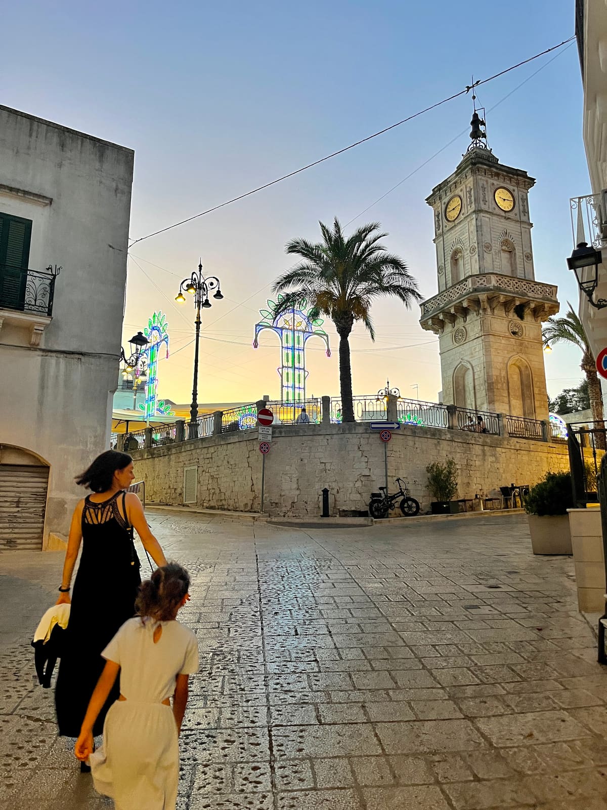 Evening passeggiata in Ceglie Messapica, clock tower and festival lights